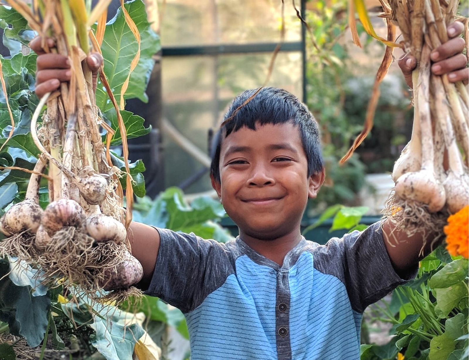 boy smiling with vegetables
